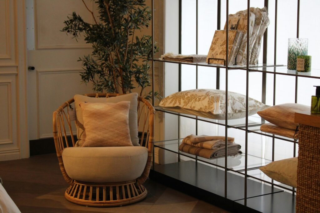Cozy interior with rattan chair, neutral cushions, and shelves highlighted by natural light showing how lighting affects color and texture